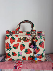The bag charm with the pink rose and the funny sailor boy
