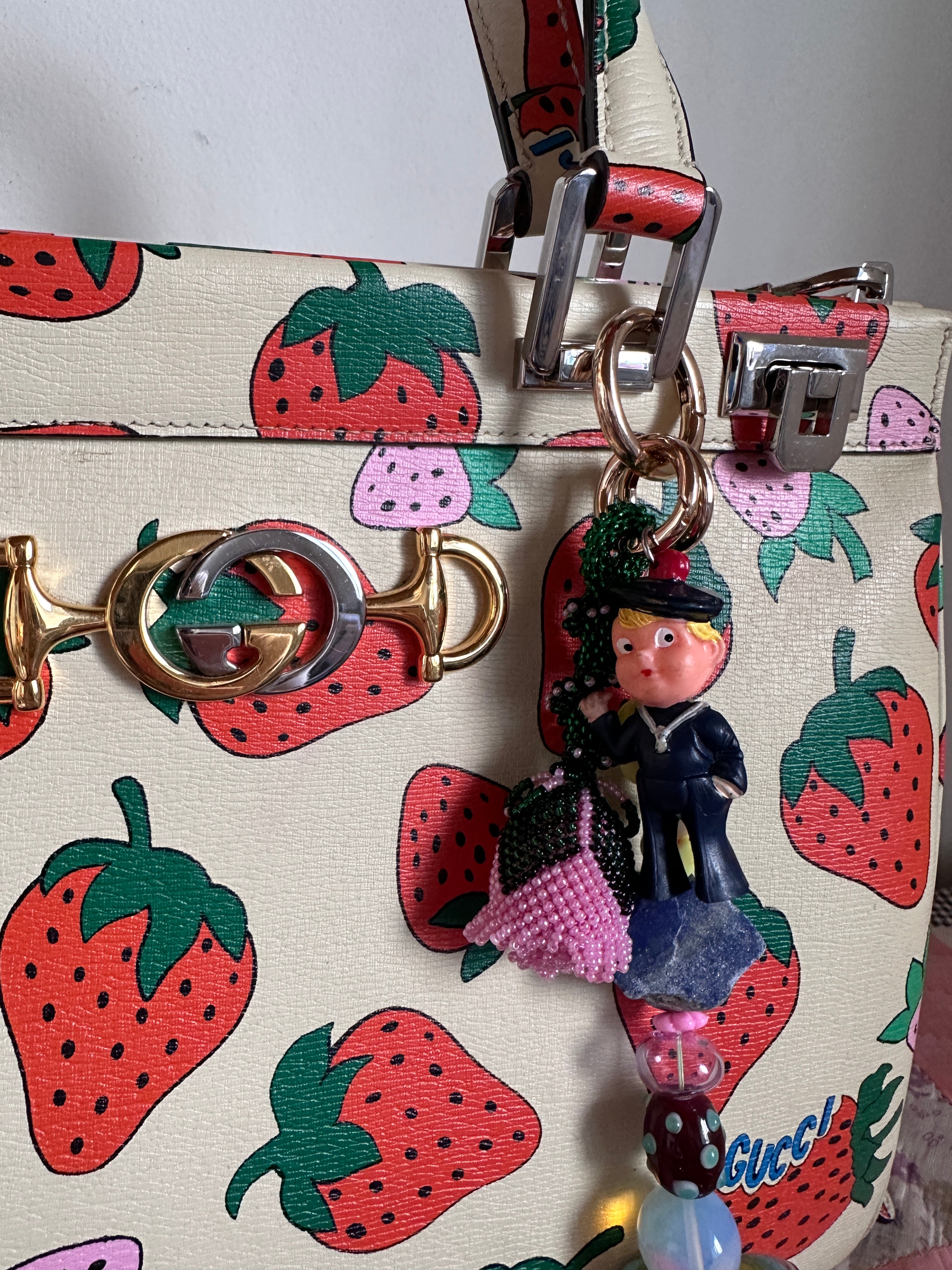 The bag charm with the pink rose and the funny sailor boy