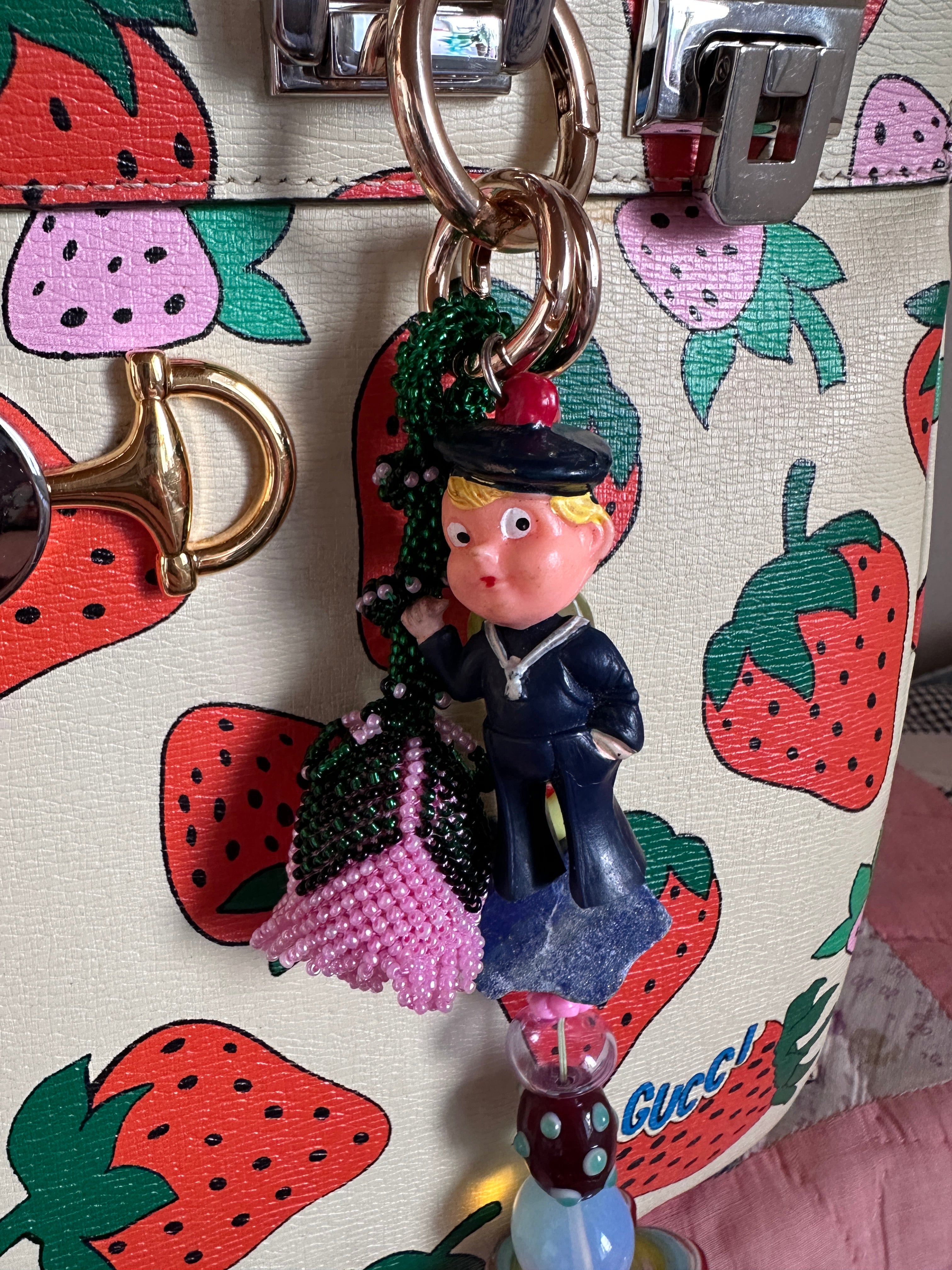 The bag charm with the pink rose and the funny sailor boy