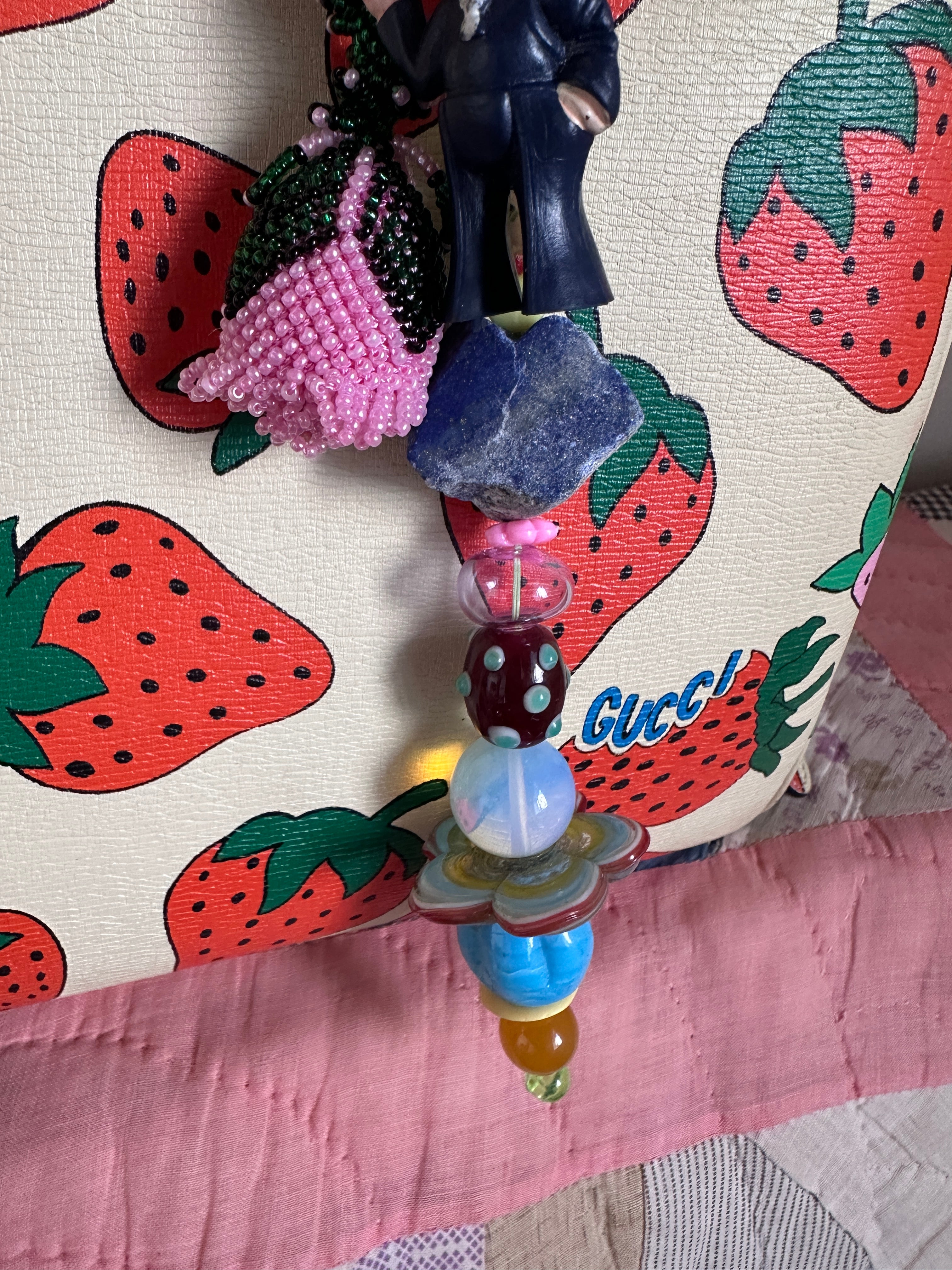 The bag charm with the pink rose and the funny sailor boy