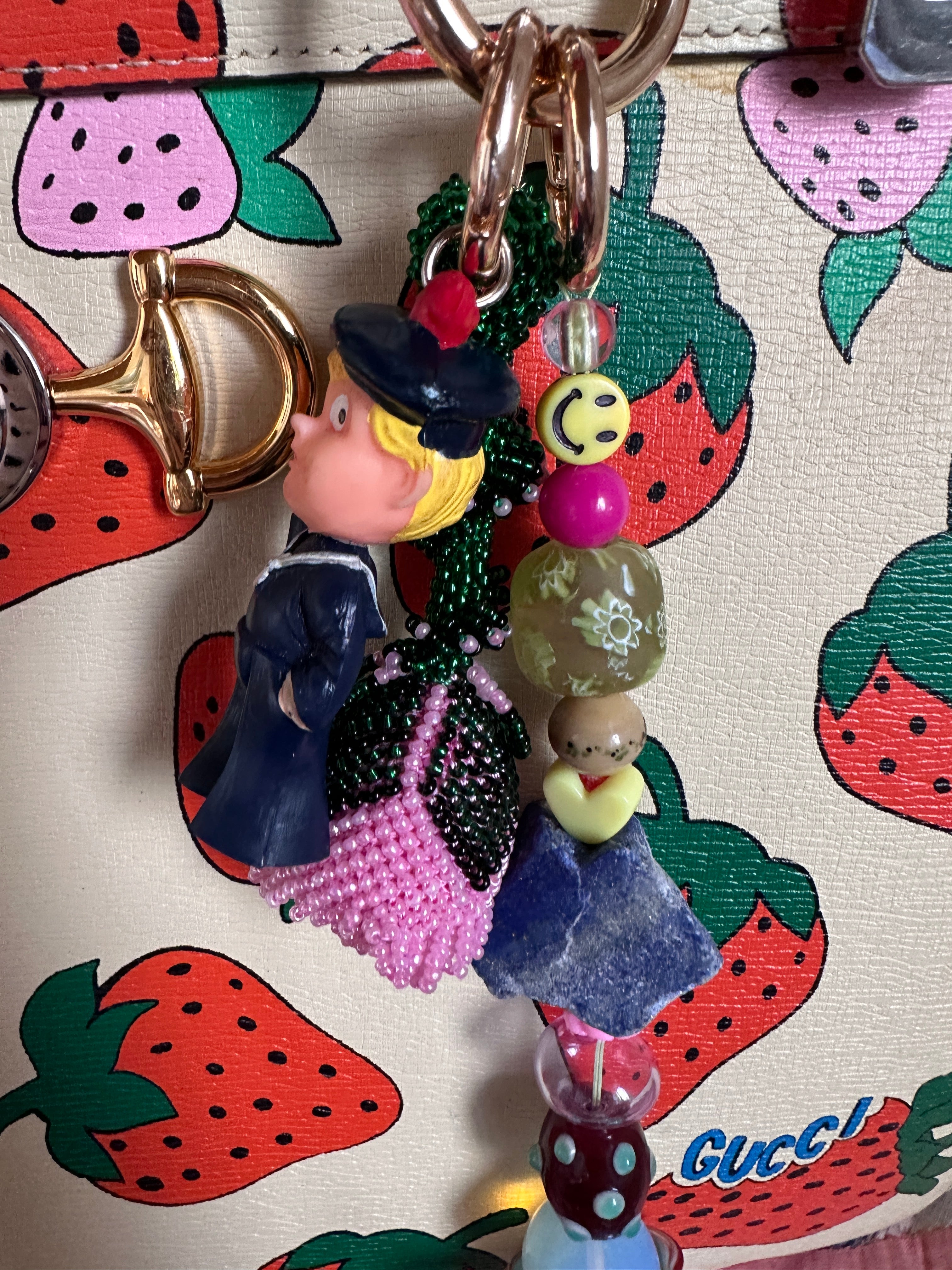 The bag charm with the pink rose and the funny sailor boy