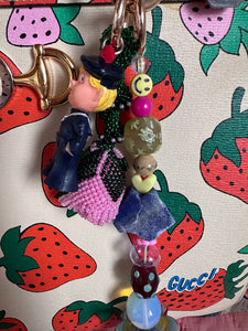 The bag charm with the pink rose and the funny sailor boy