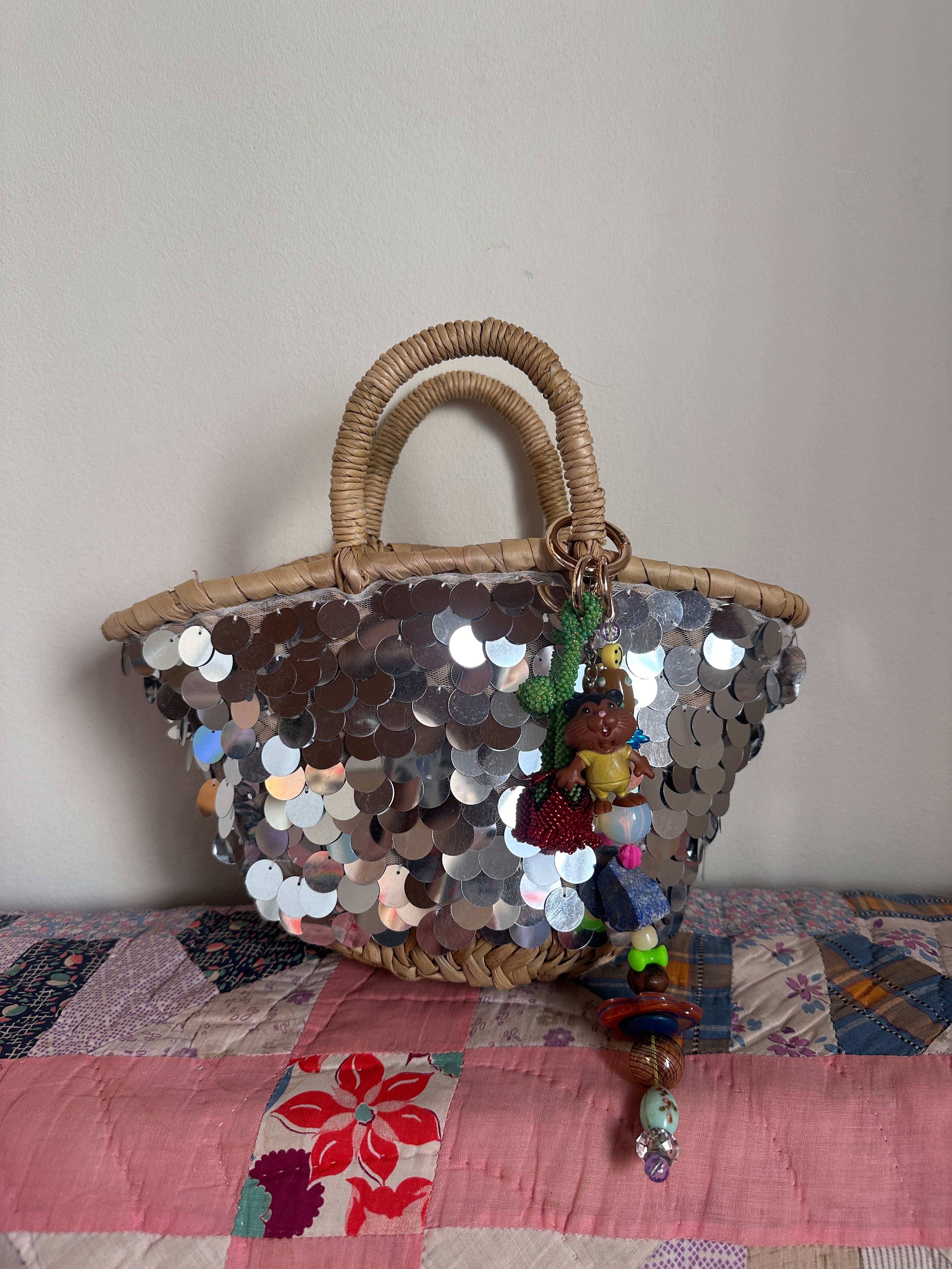 The bag charm with the red rose and the funny beaver