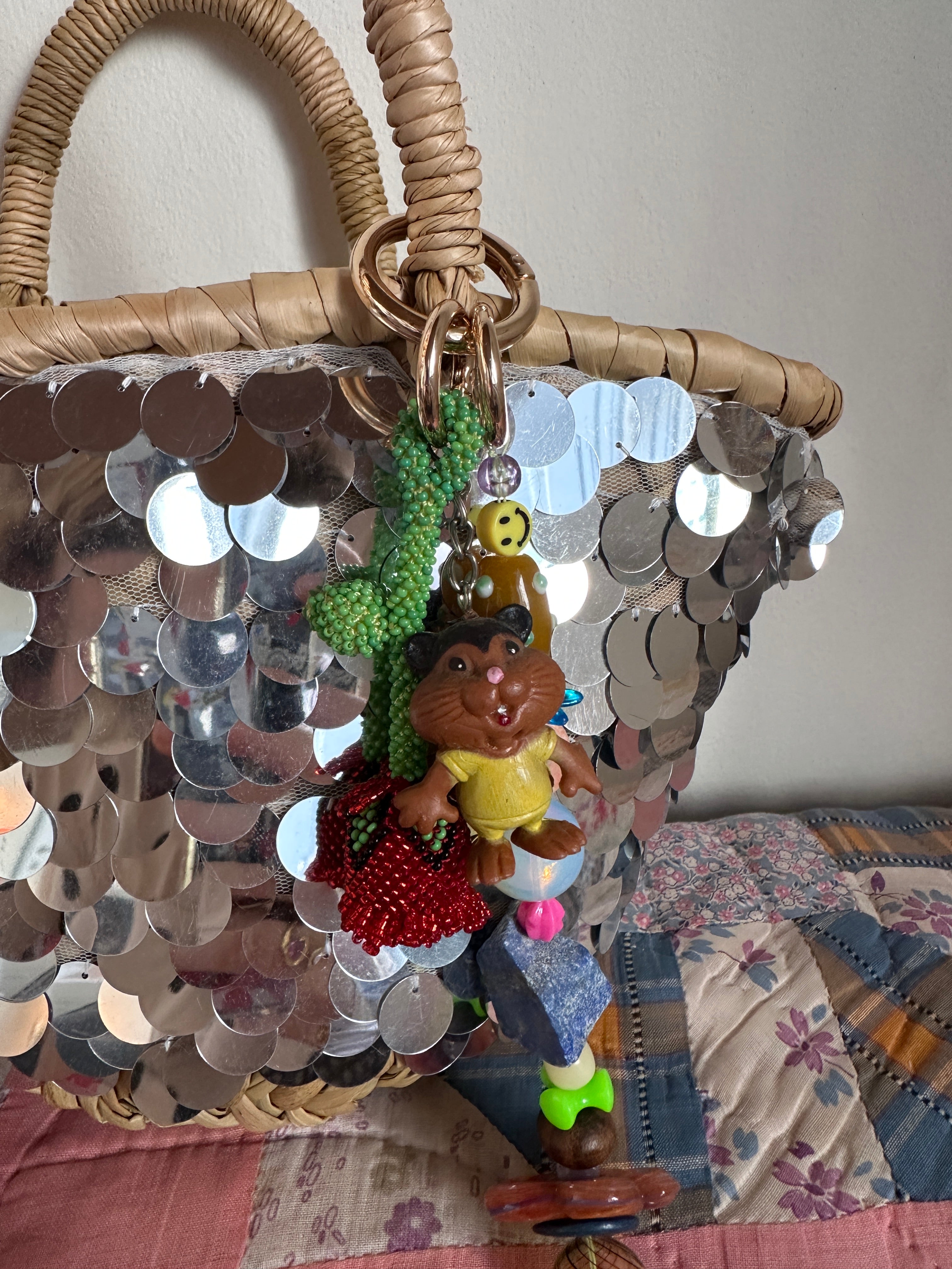 The bag charm with the red rose and the funny beaver