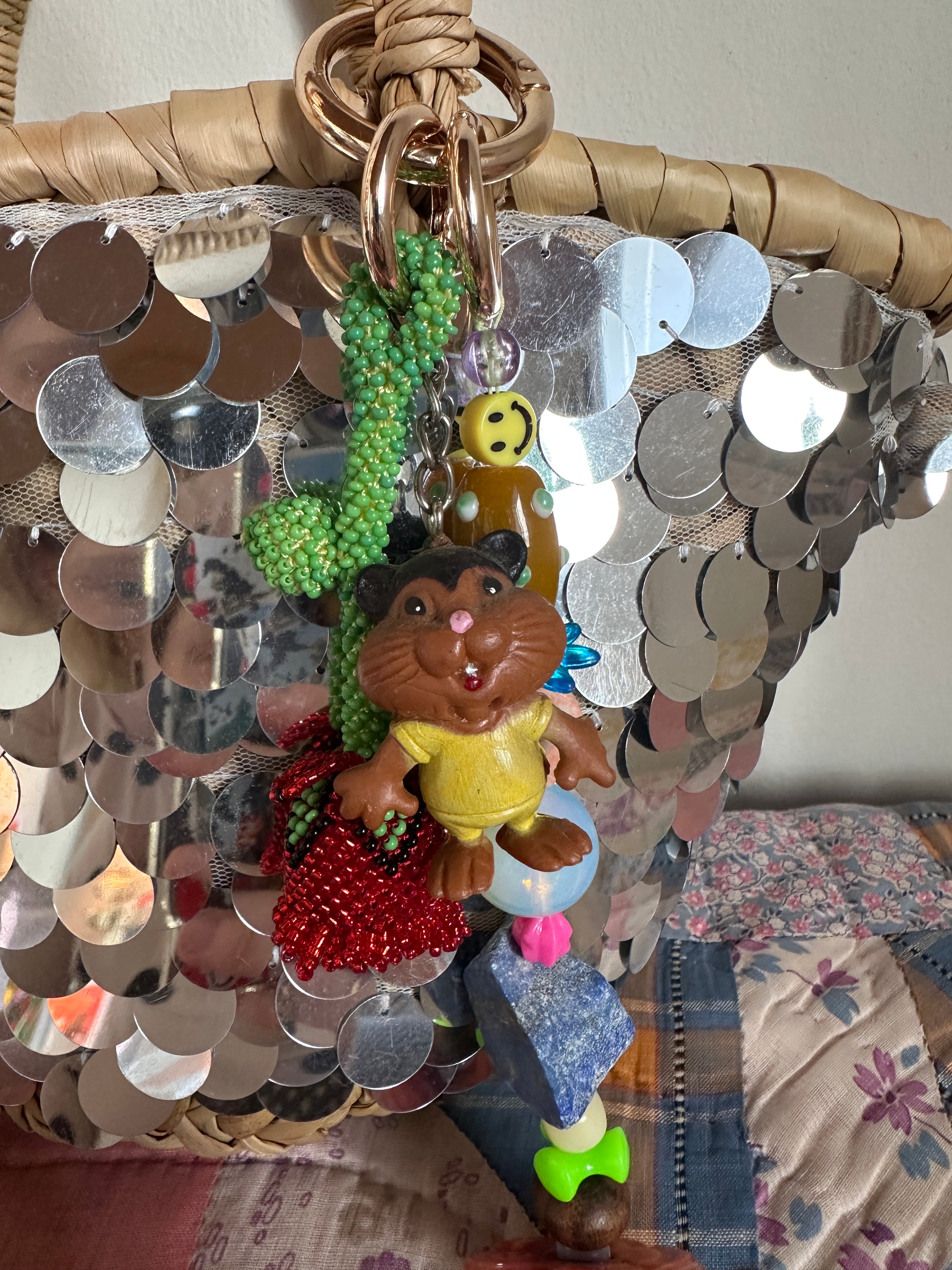 The bag charm with the red rose and the funny beaver