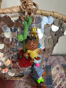 The bag charm with the red rose and the funny beaver