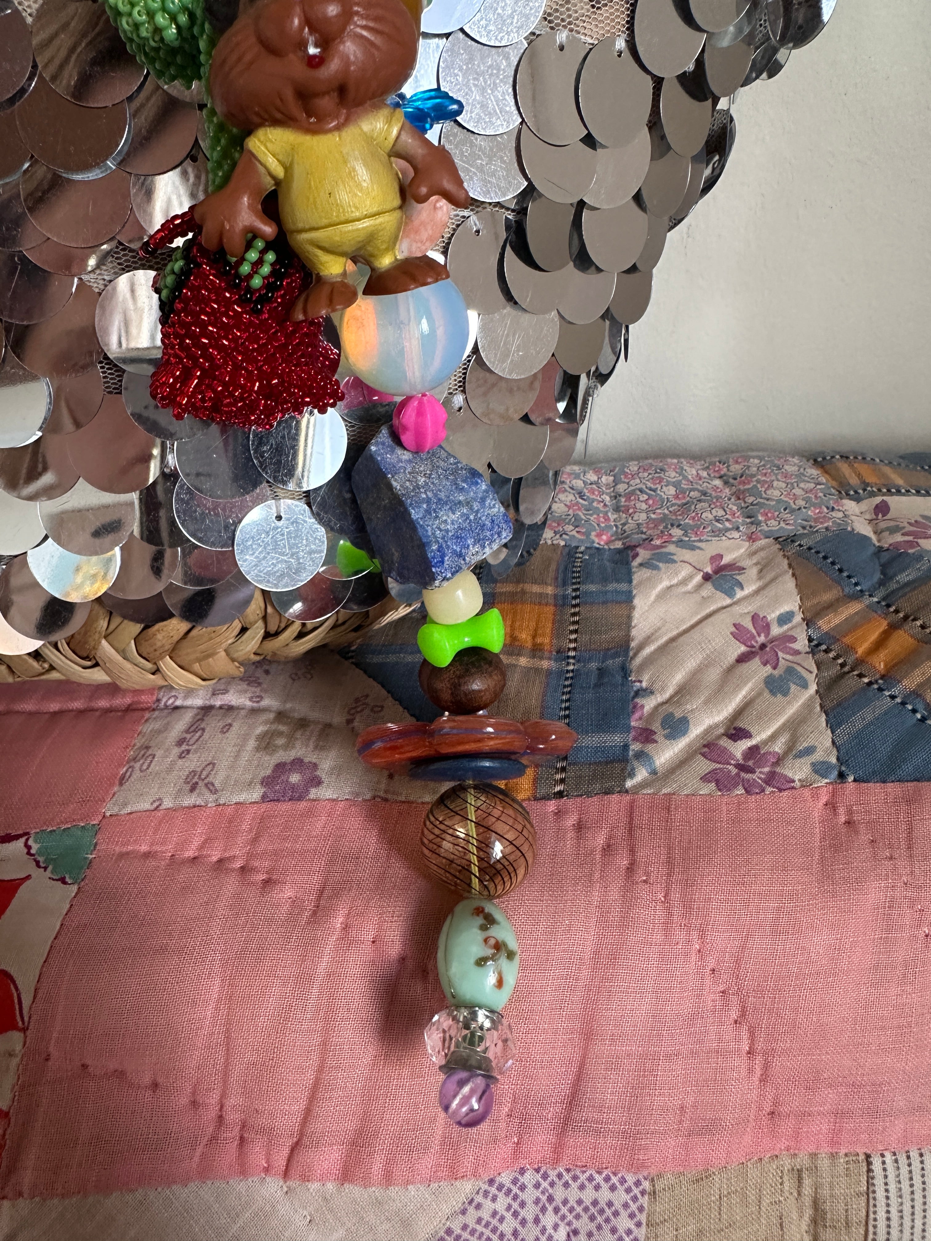 The bag charm with the red rose and the funny beaver