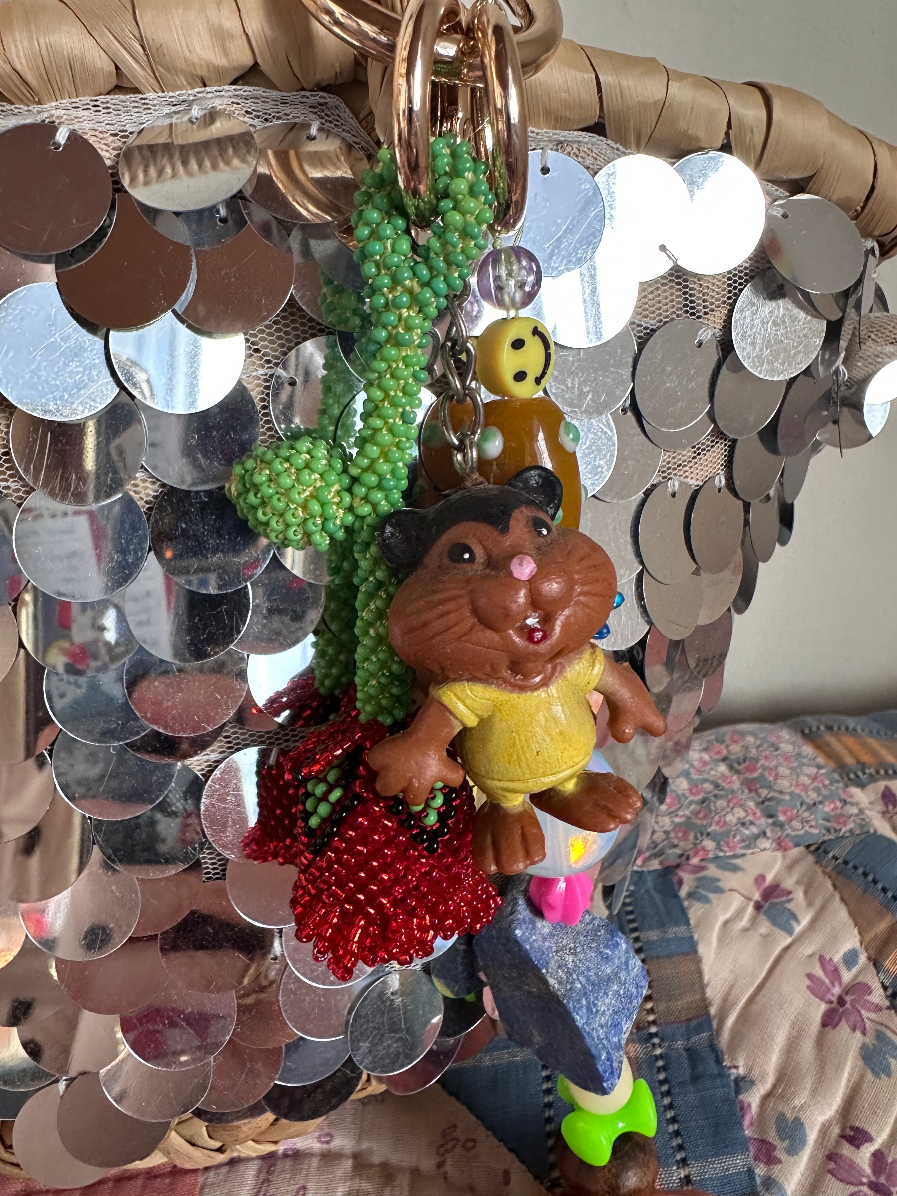 The bag charm with the red rose and the funny beaver