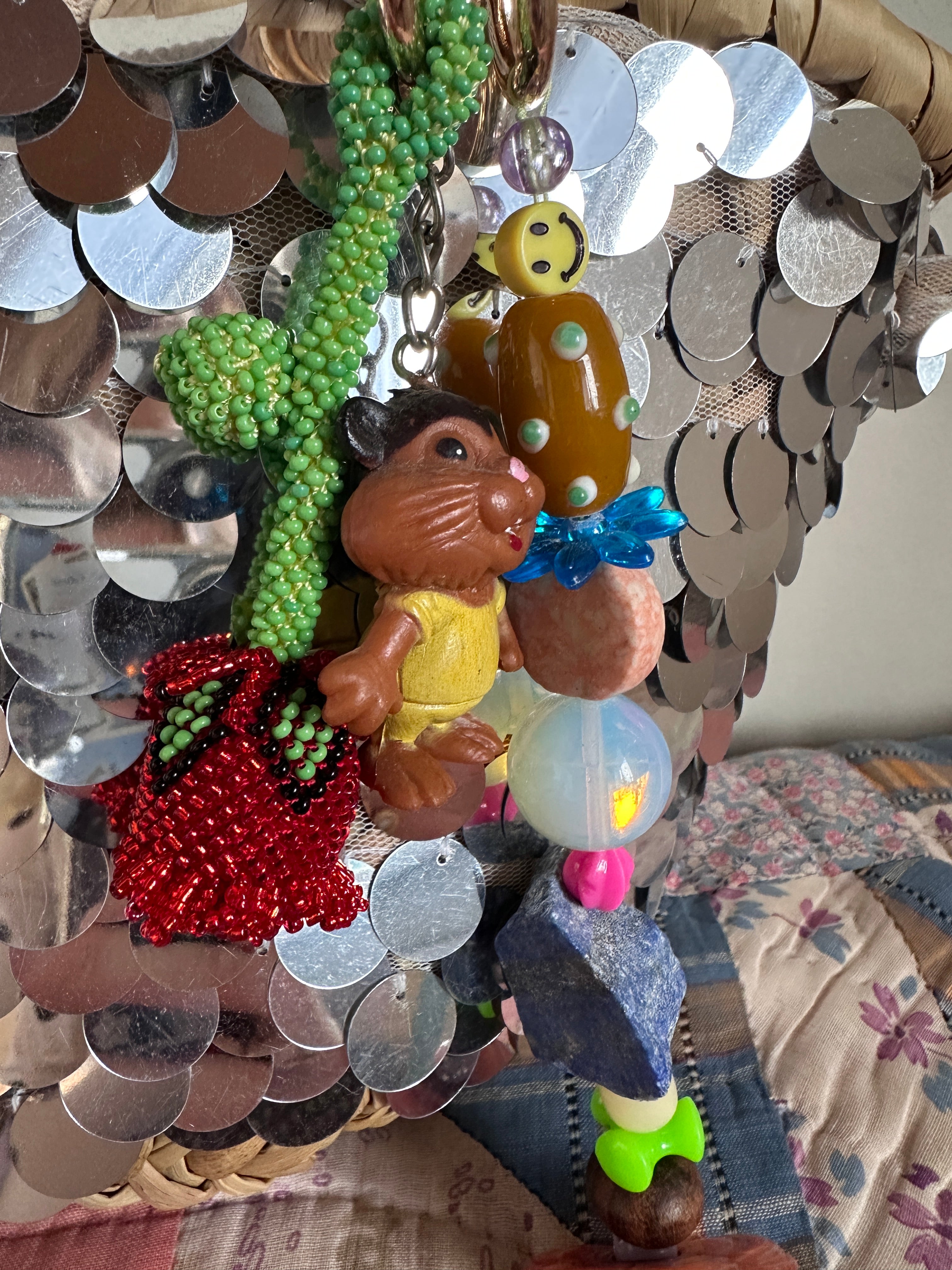 The bag charm with the red rose and the funny beaver