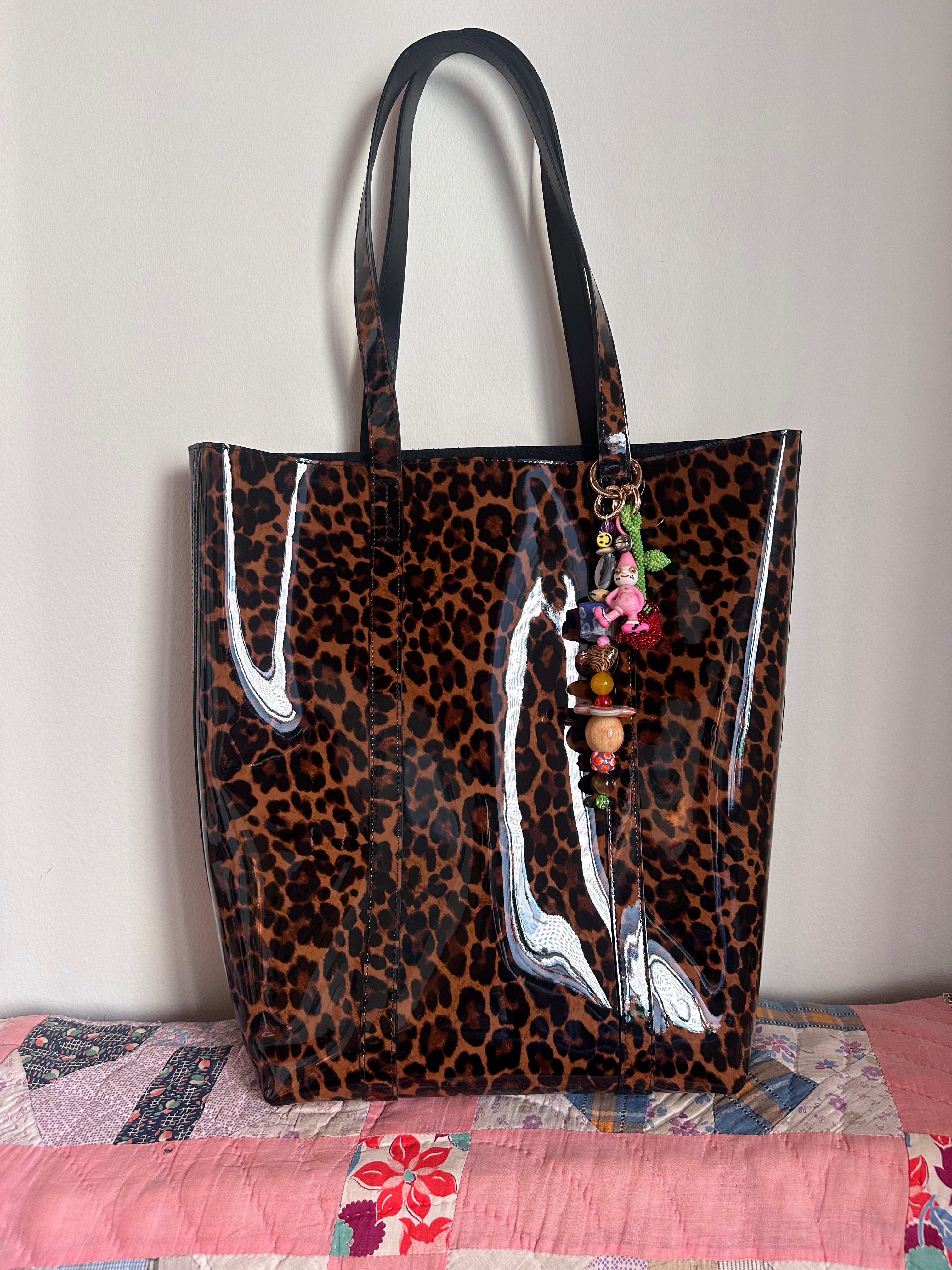 The bag charm with the red rose and the funny pink clown