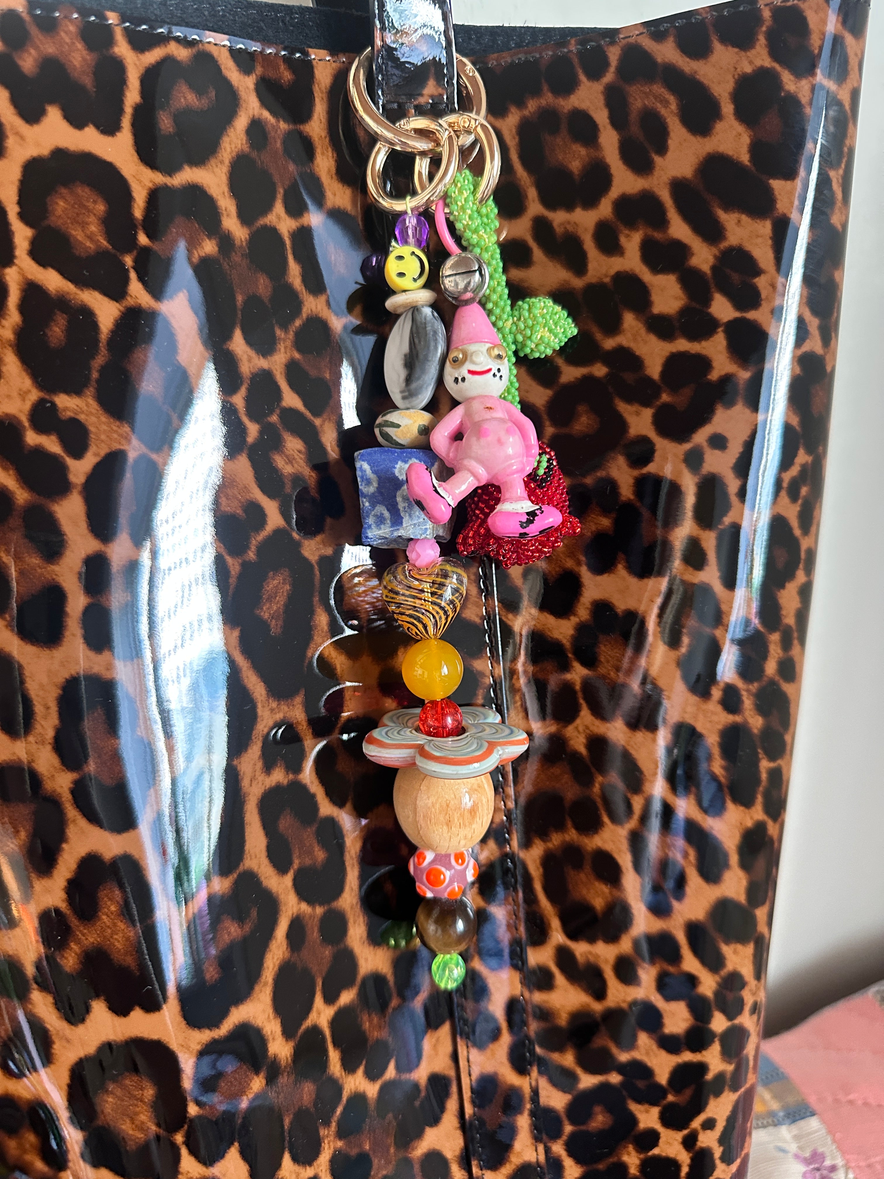 The bag charm with the red rose and the funny pink clown
