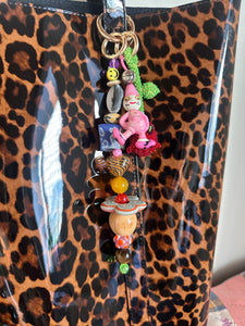 The bag charm with the red rose and the funny pink clown