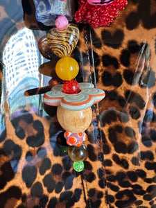 The bag charm with the red rose and the funny pink clown