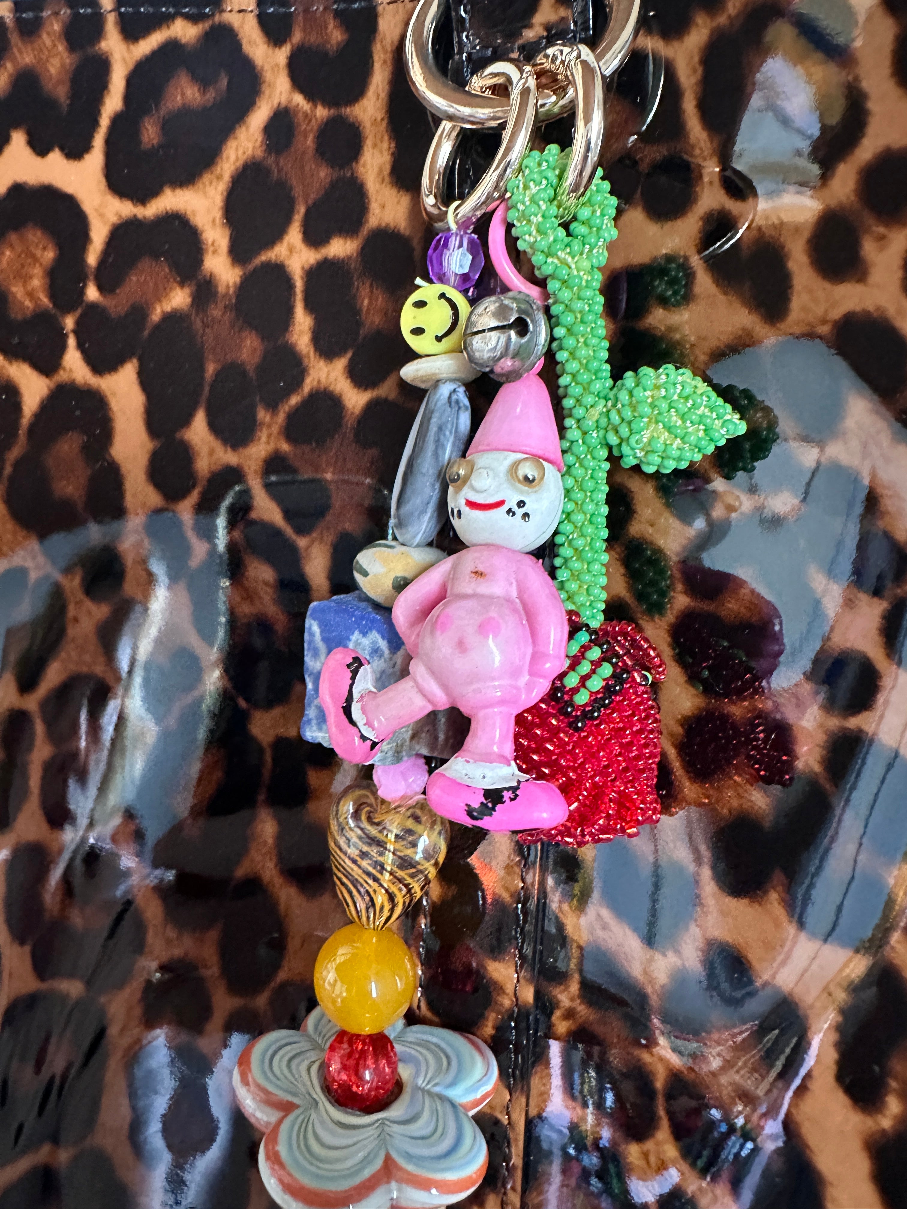 The bag charm with the red rose and the funny pink clown