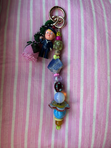 The bag charm with the pink rose and the funny sailor boy