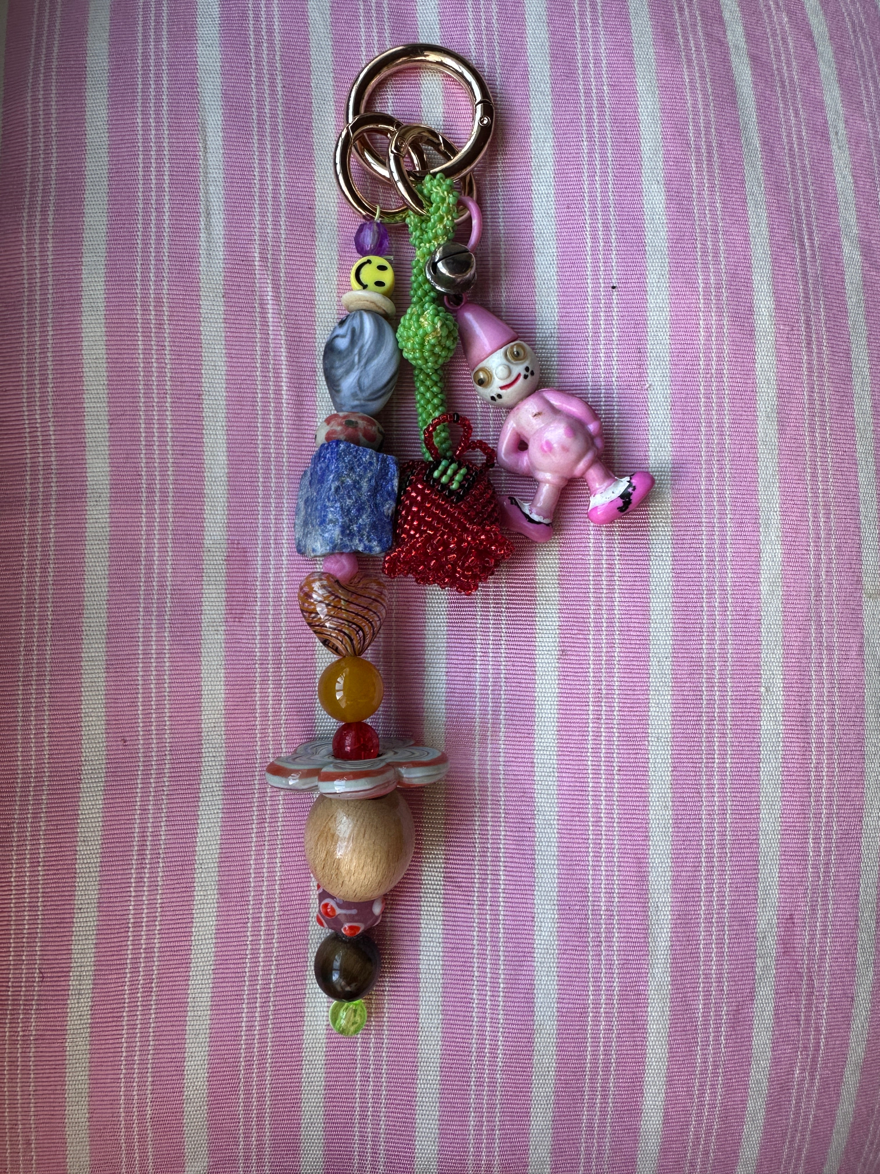 The bag charm with the red rose and the funny pink clown