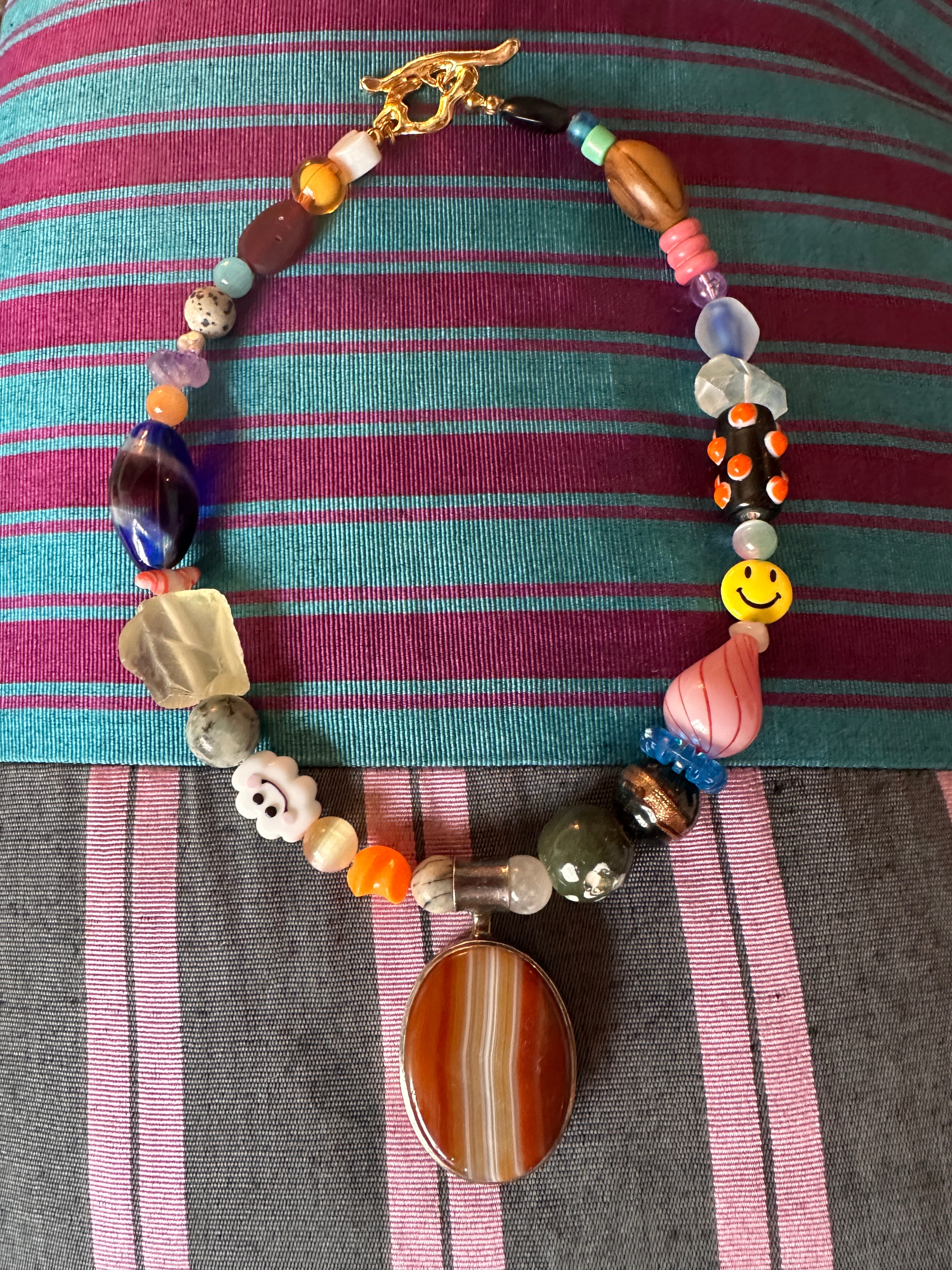 The one with the happy cloud and the silver and agate pendant