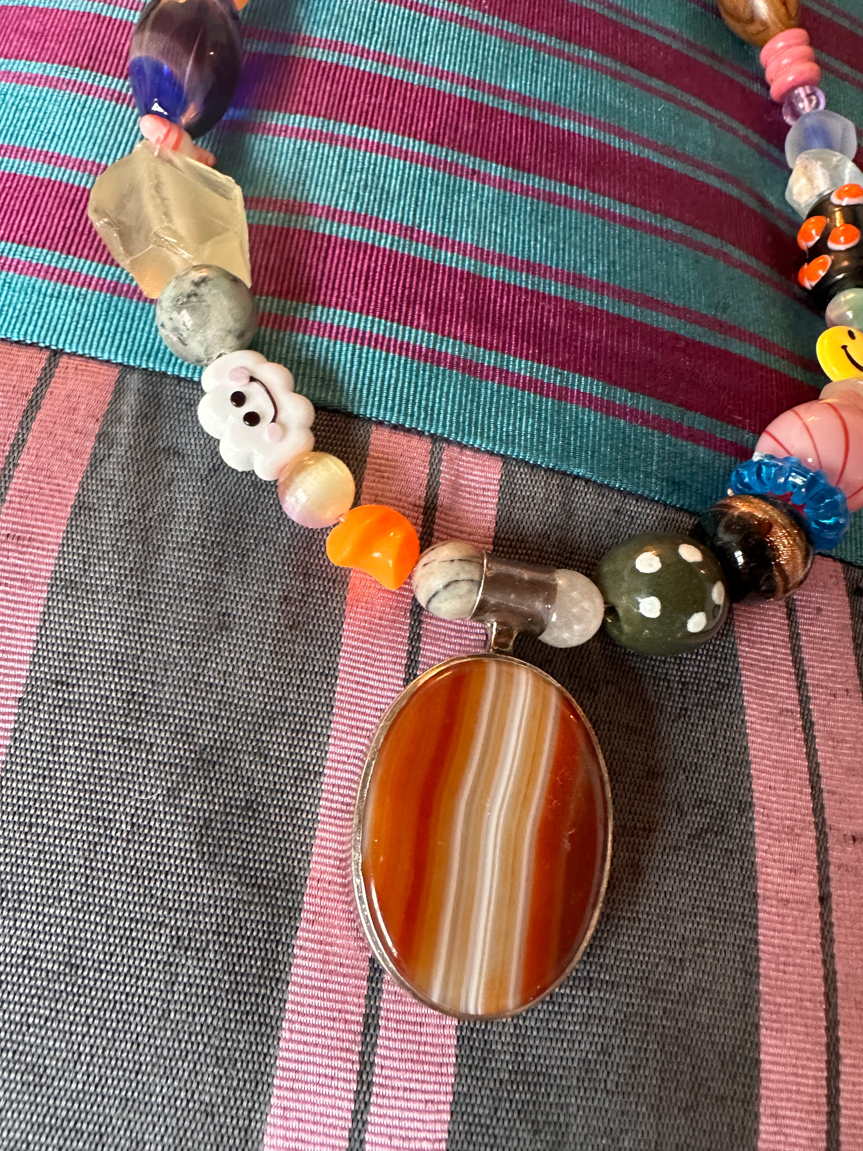 The one with the happy cloud and the silver and agate pendant