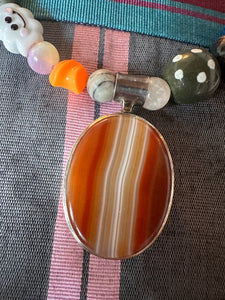 The one with the happy cloud and the silver and agate pendant